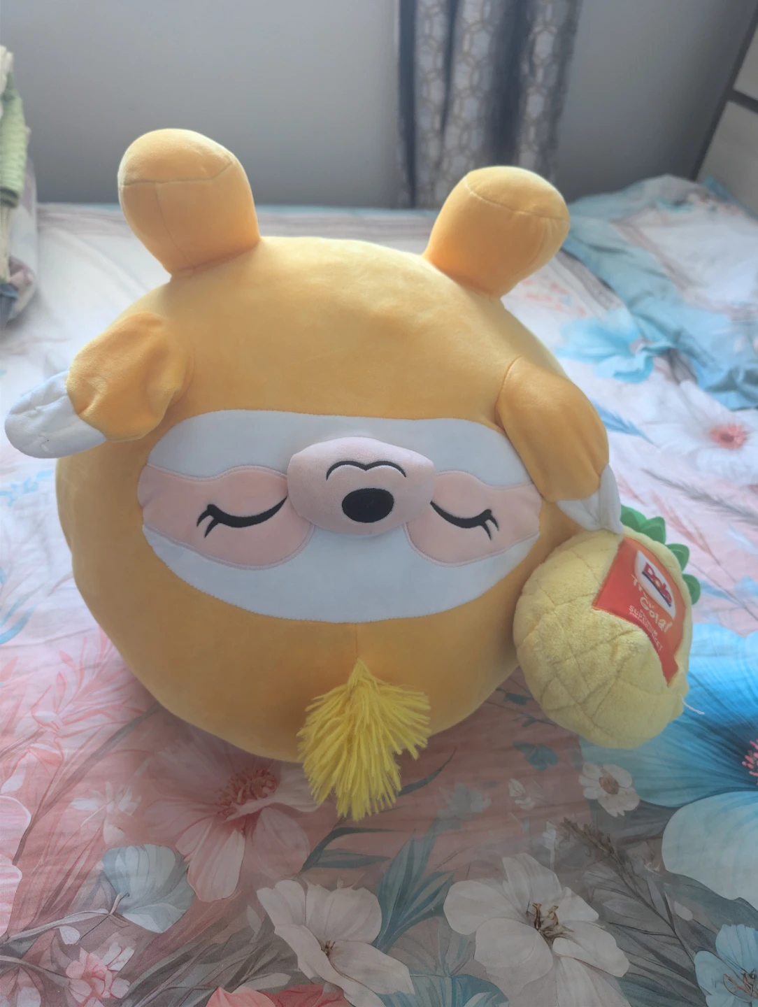 Squishmallow yellow sloth plush with pineapple