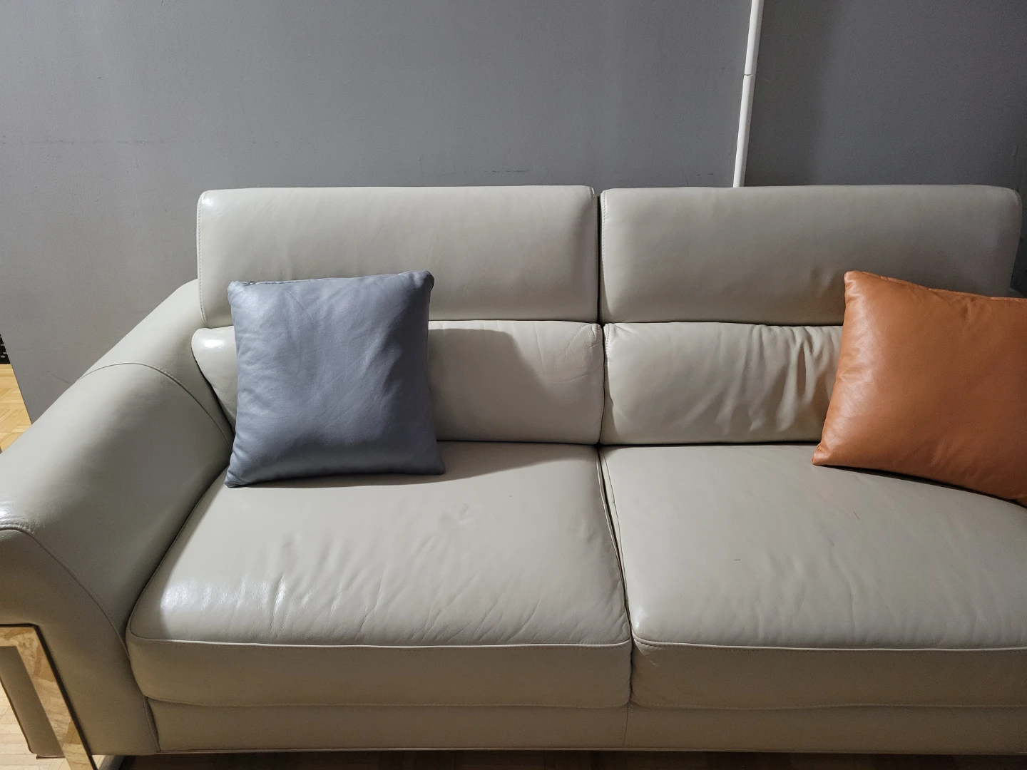 Cream Leather Sofa with Decorative Pillows