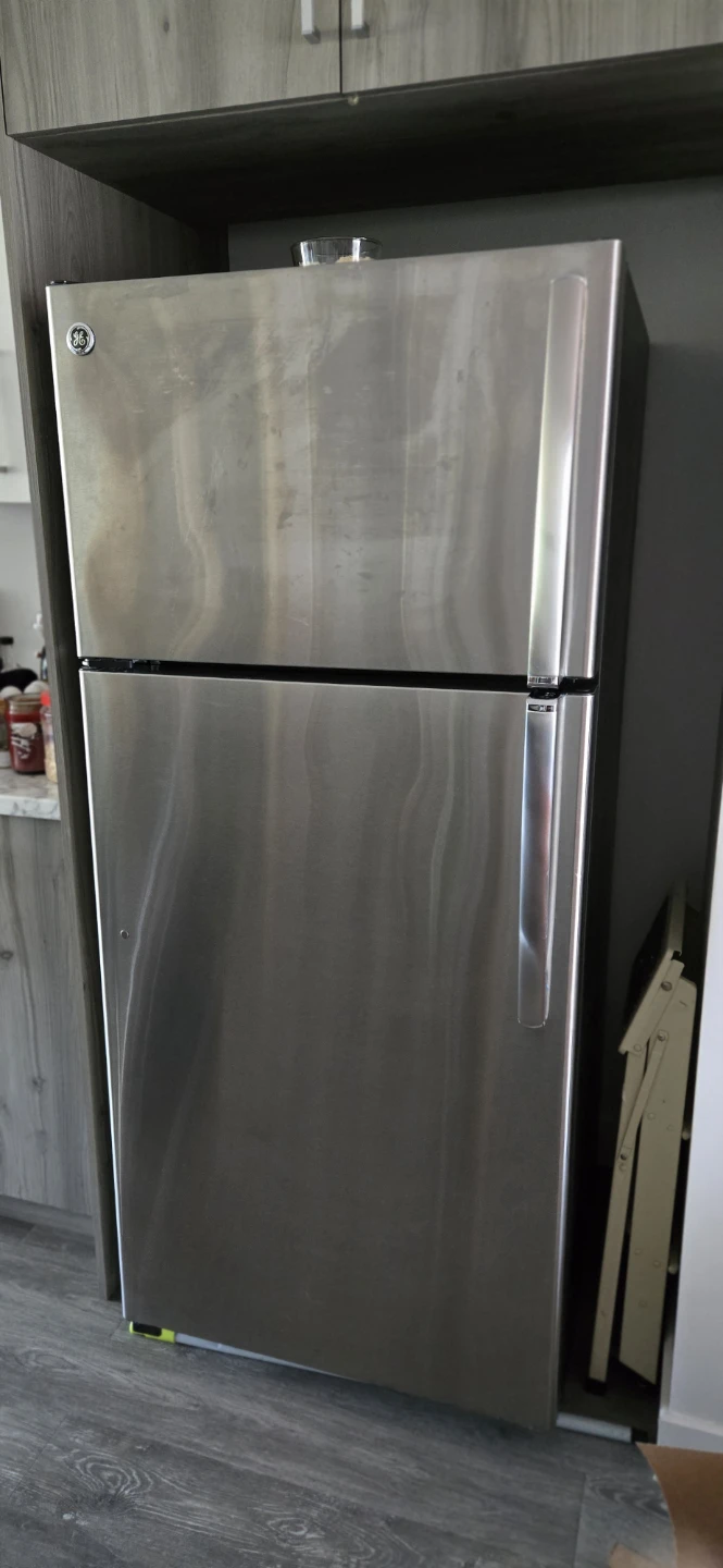 Black Electric Range and Stainless Steel GE Fridge