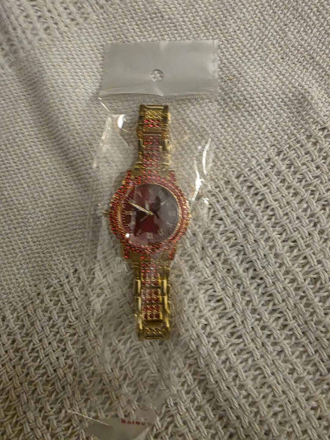 Gold-tone watch with red stones