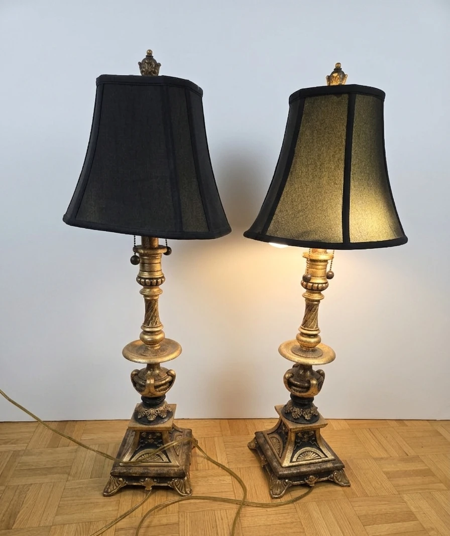 Pair of ornate gold table lamps with black shades