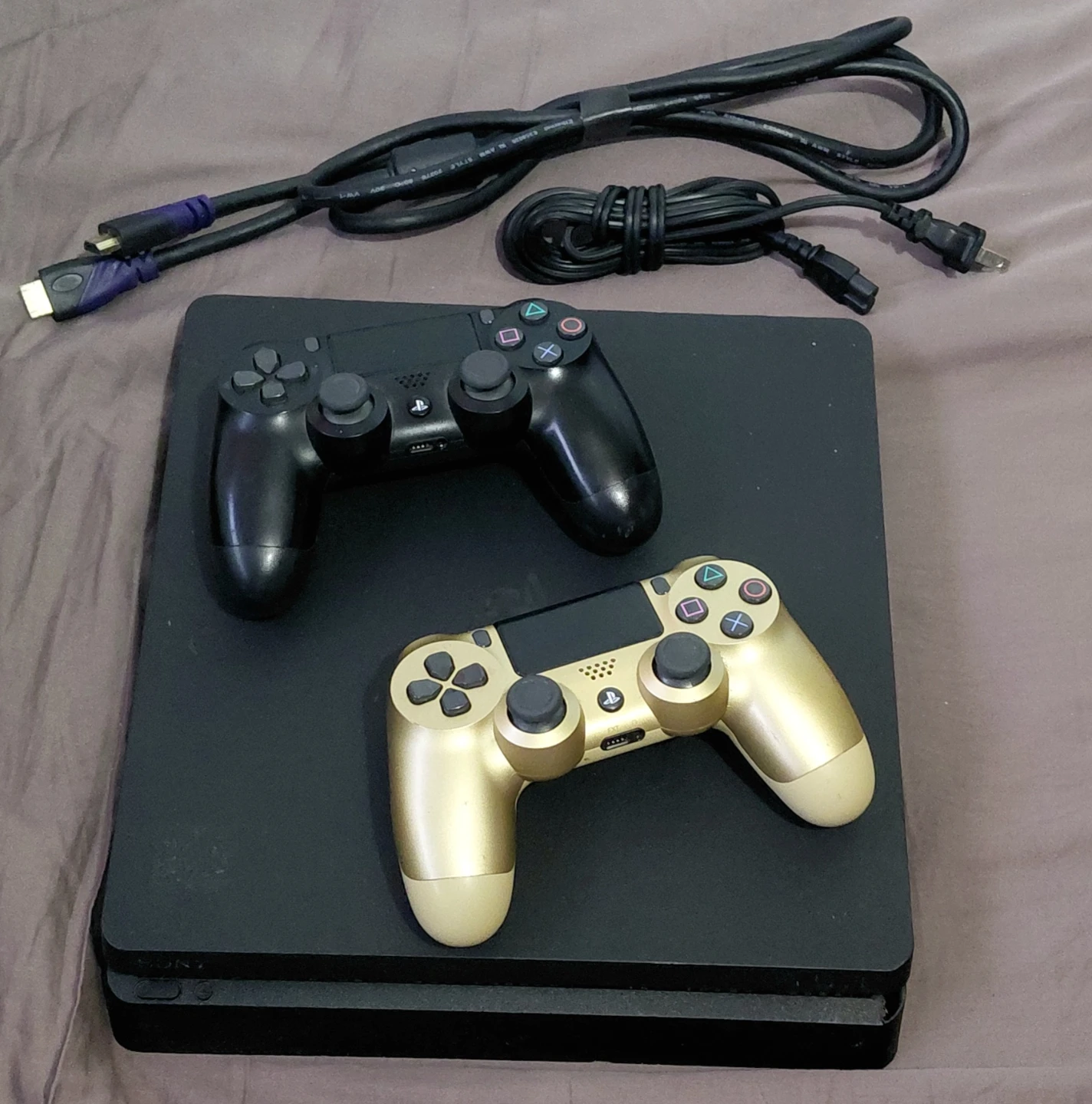 The Sony PlayStation 4 Slim (CUH-2215B) is a 1TB "Slim" model