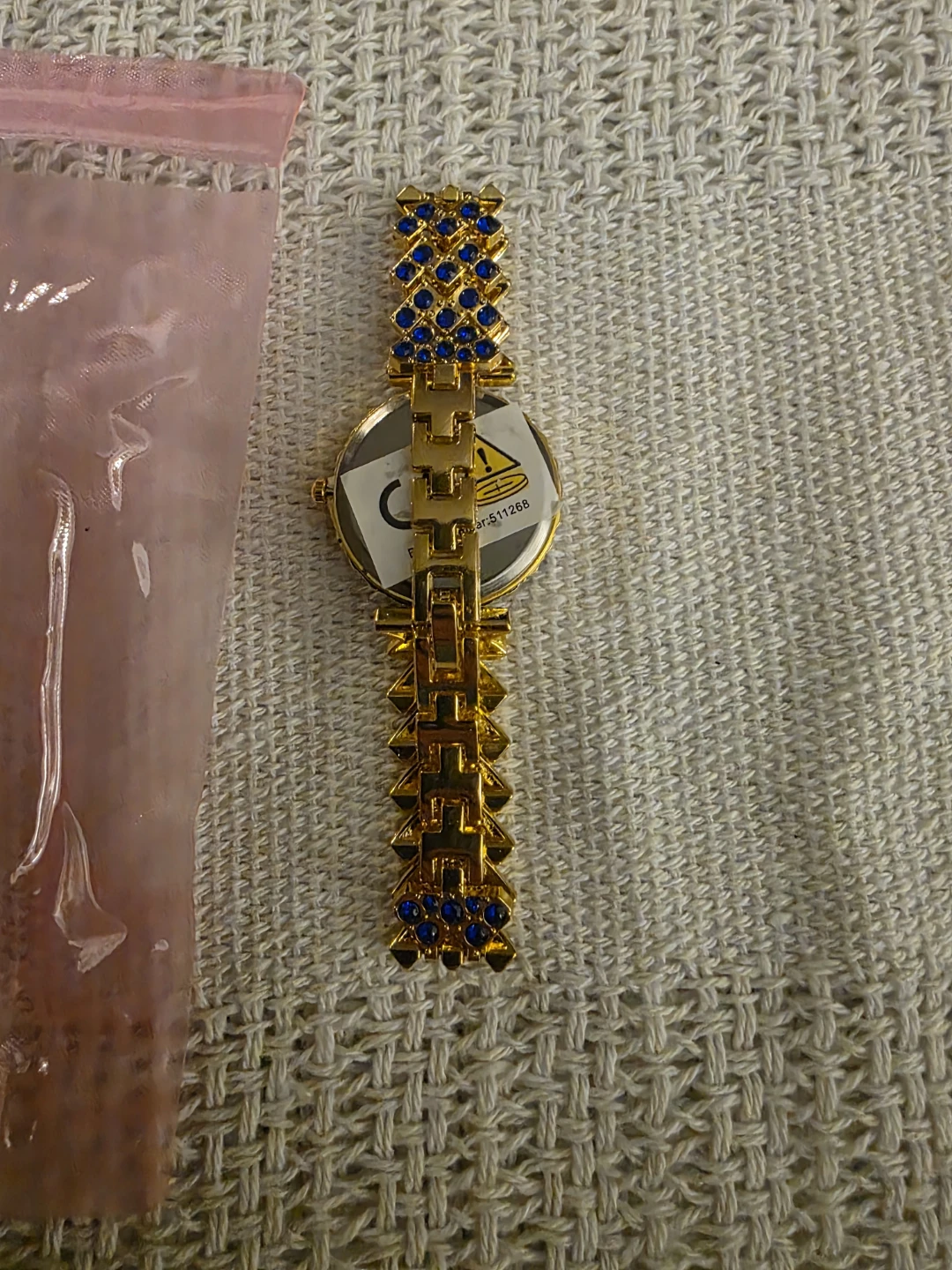 Gold-tone watch with blue accent bracelet