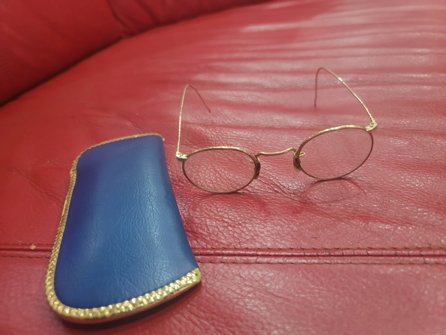 Gold wire frame reading glasses with blue case
