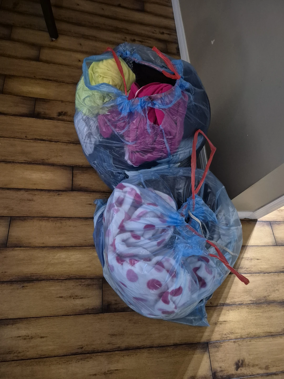 Bundle of assorted clothing and blankets