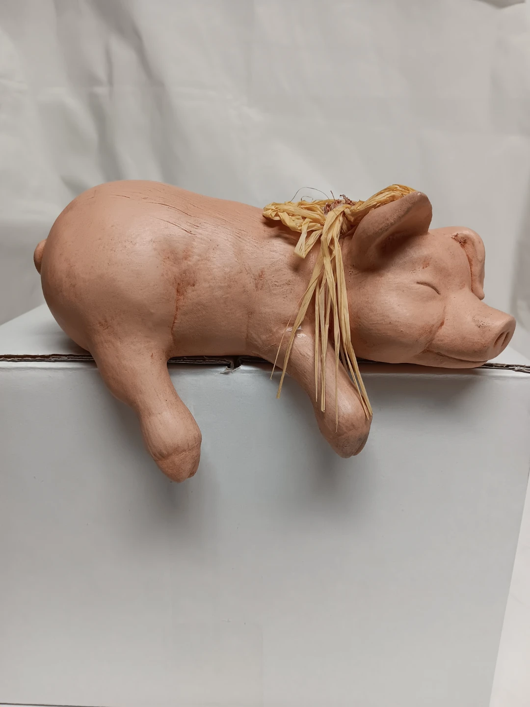 Ceramic Sleeping Pig Figurine with Straw Accent