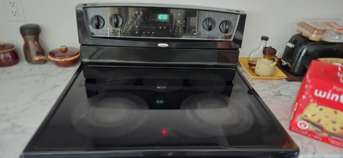 Black Electric Range and Stainless Steel GE Fridge - photo 2