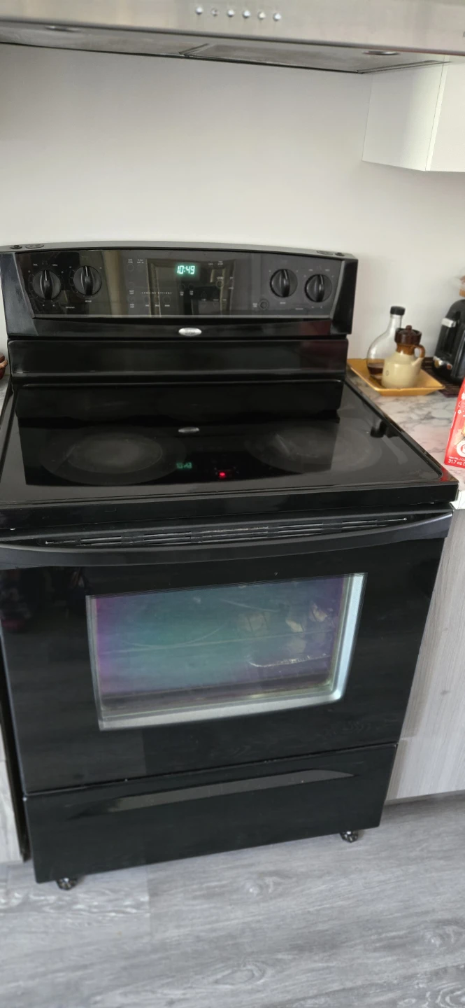 Black Electric Range and Stainless Steel GE Fridge - photo 3
