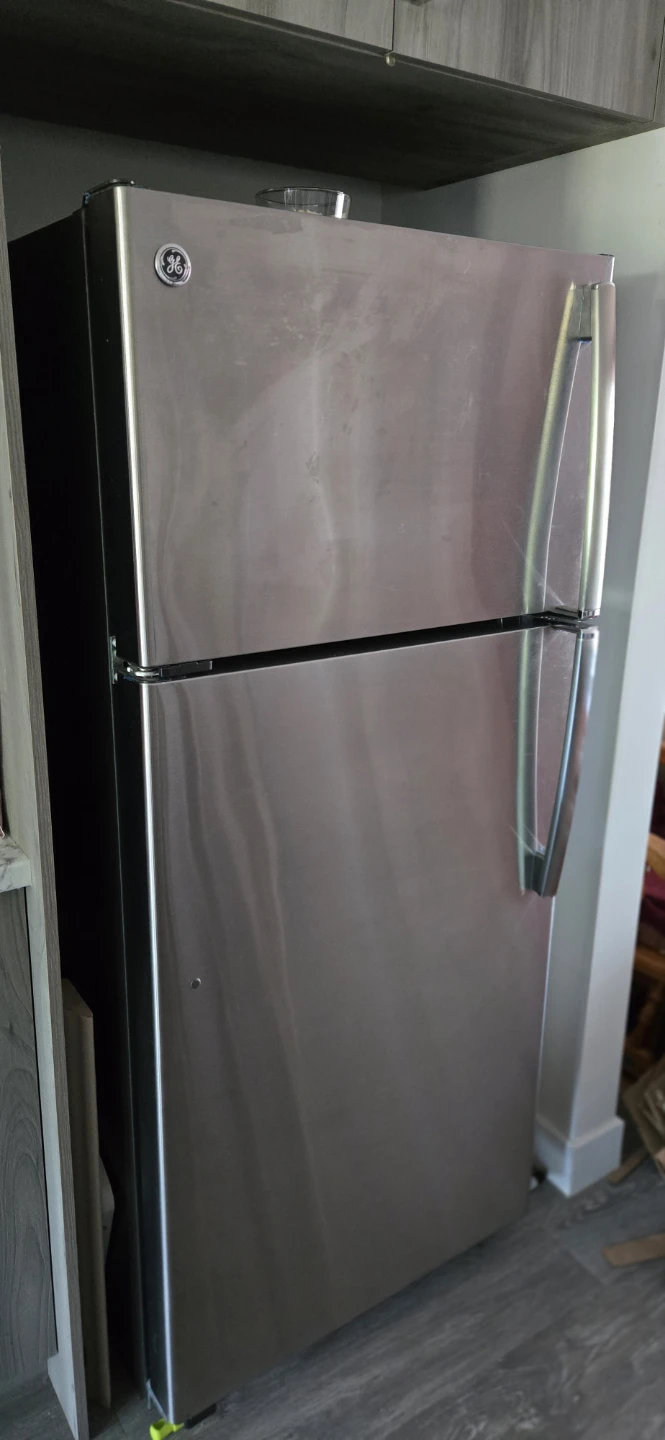Black Electric Range and Stainless Steel GE Fridge - photo 4