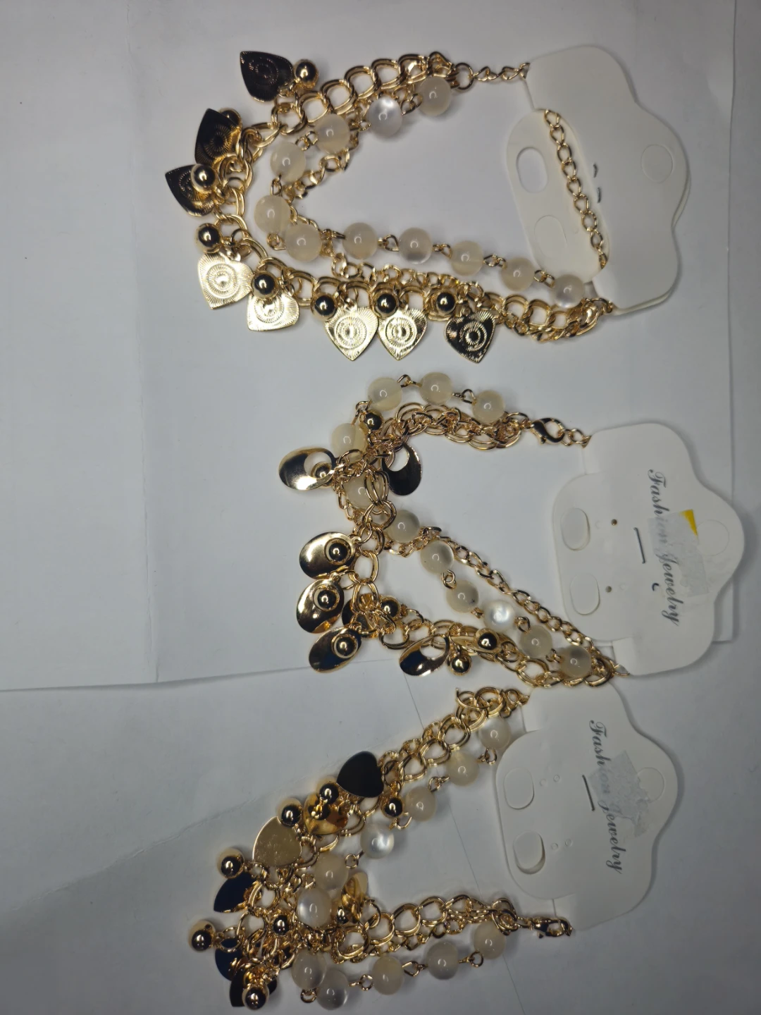 Gold tone charm bracelets with beads