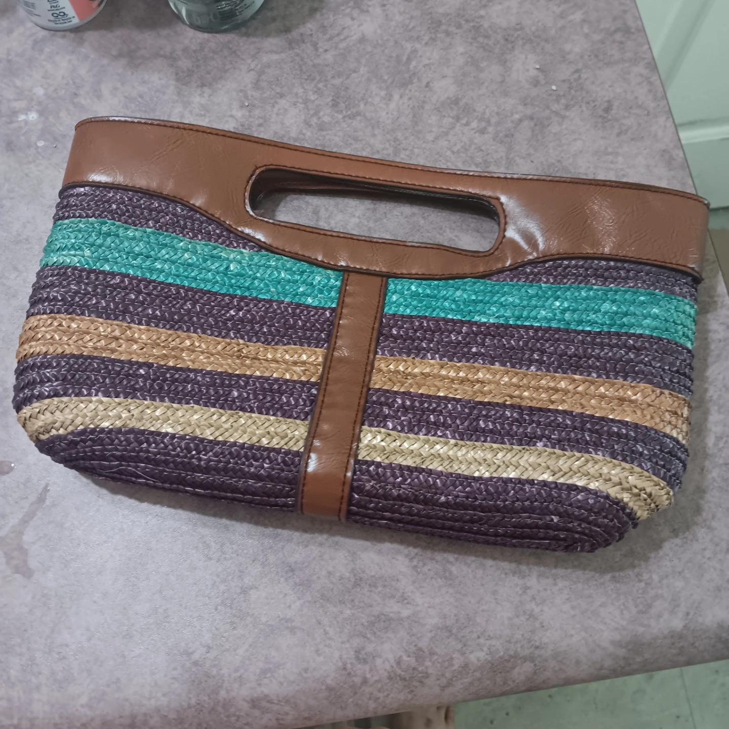 Striped straw clutch with brown vegan leather trim