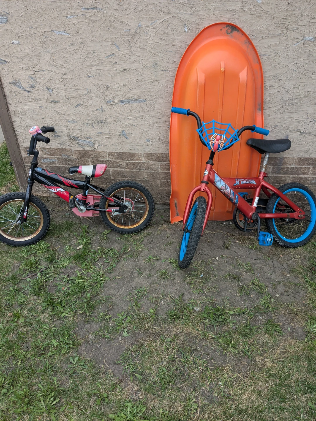 Two kids' bikes: Spiderman and pink/black