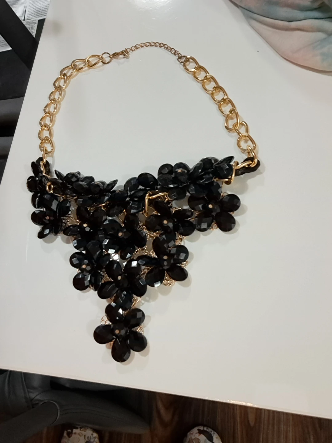 Black and gold tone floral statement necklace