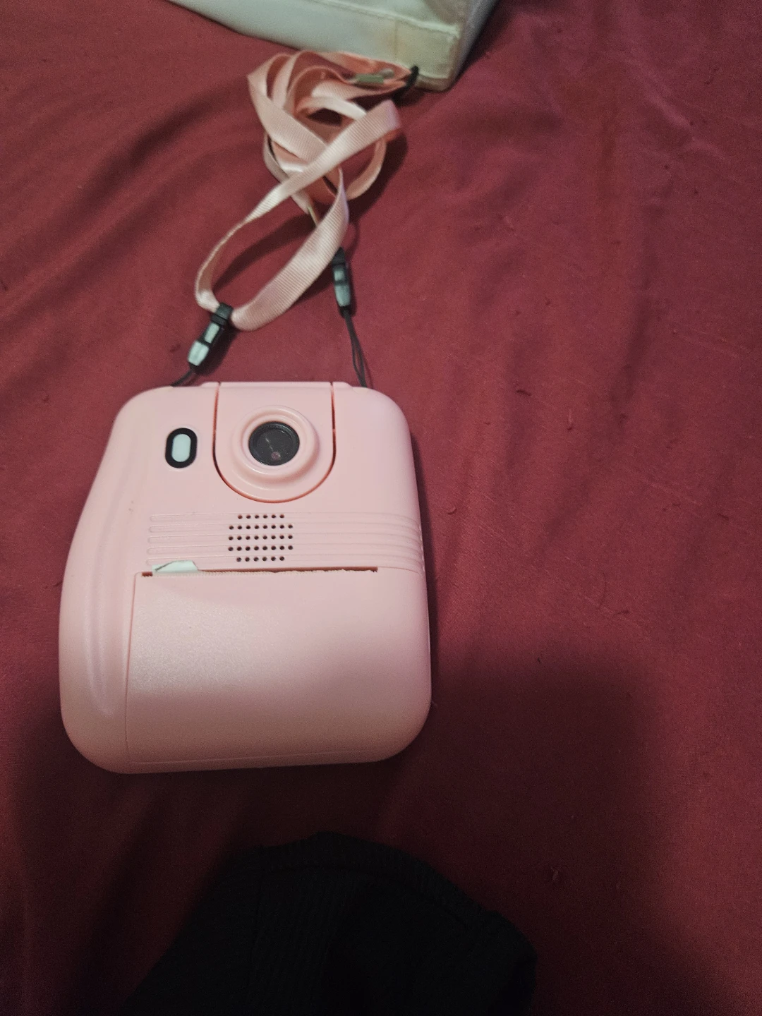Pink instant camera with lanyard