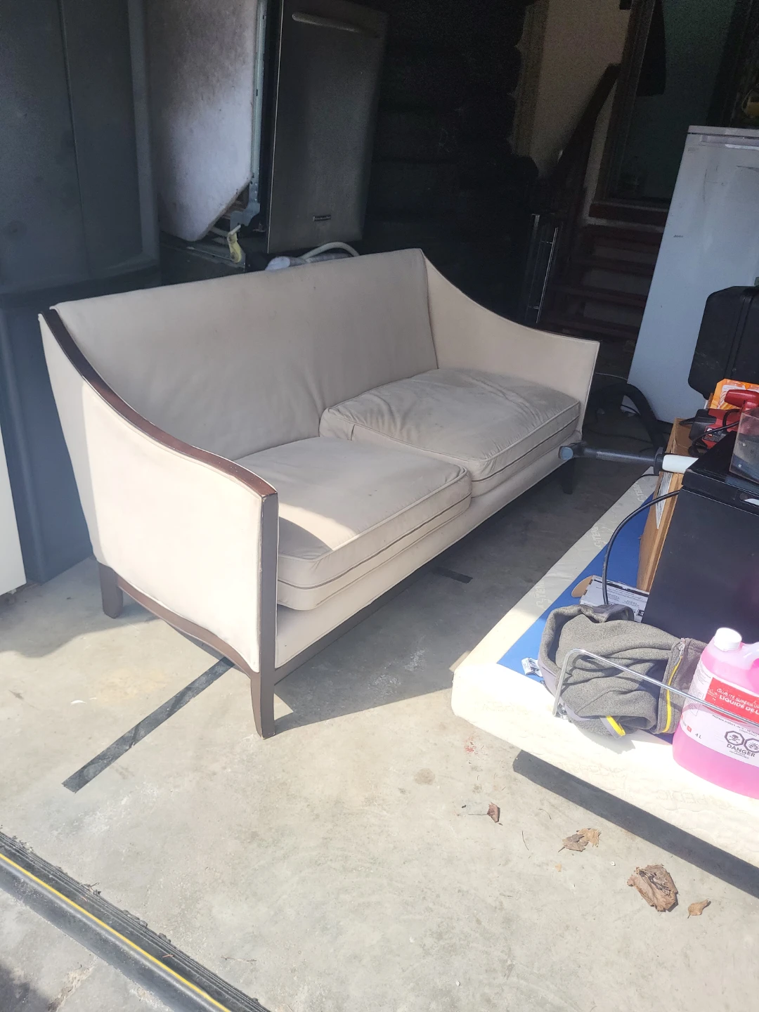 Cream loveseat with wood trim
