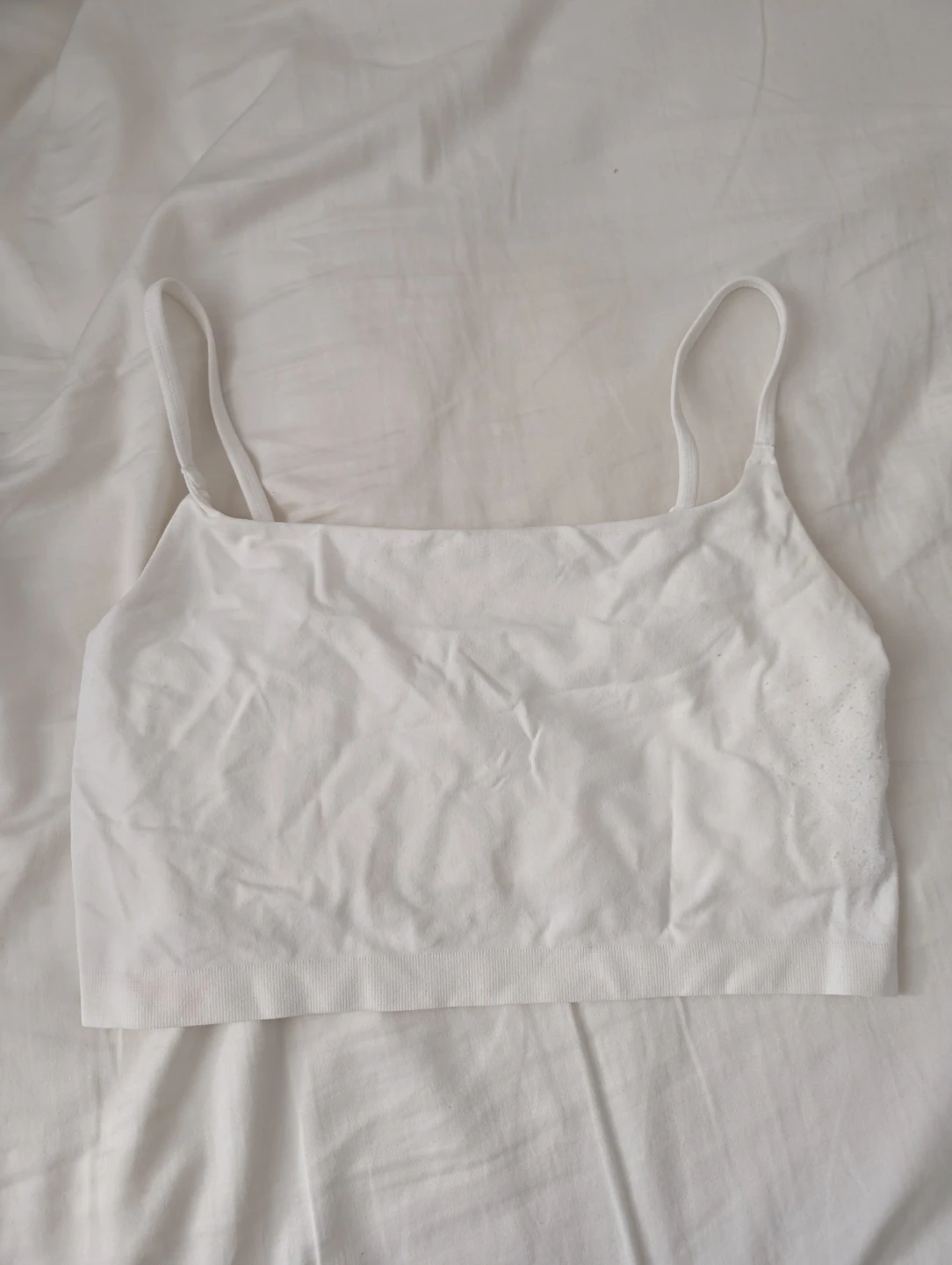 Primark Cares White Seamless Crop Top piled at the side