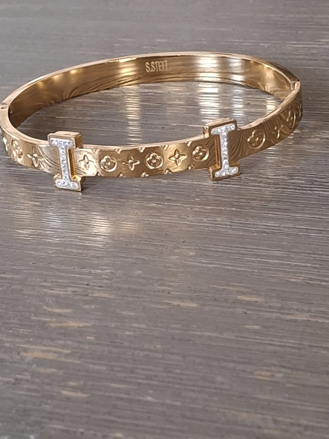 Gold tone cuff bracelet with decorative pattern and stones - photo 2
