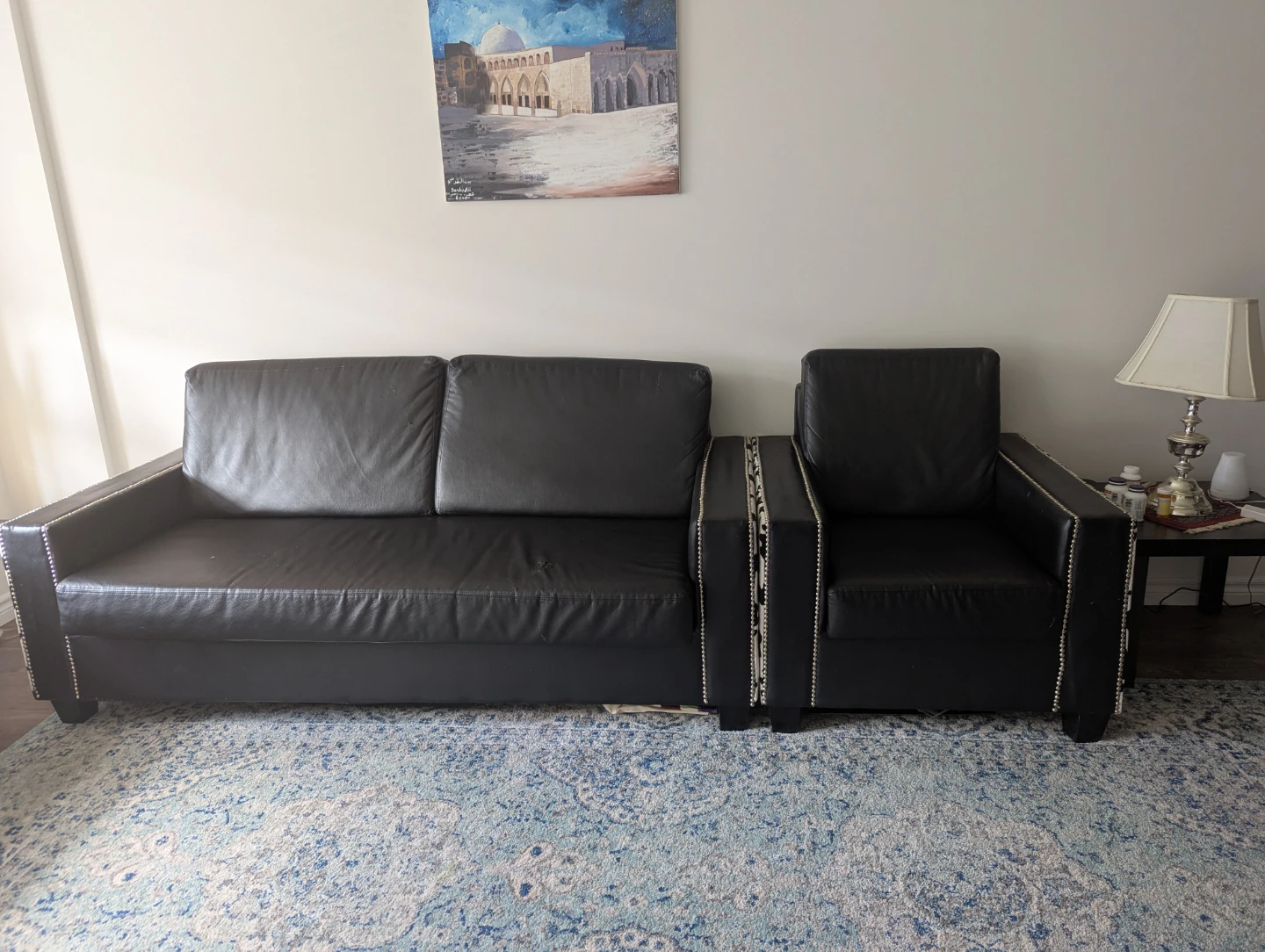 Black faux leather couch and armchair set with cow print accents - photo 2