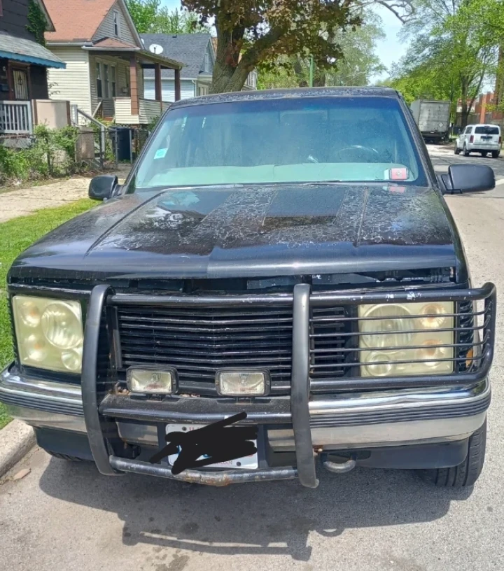 Black Chevrolet 4x4 Truck with Camper Shell