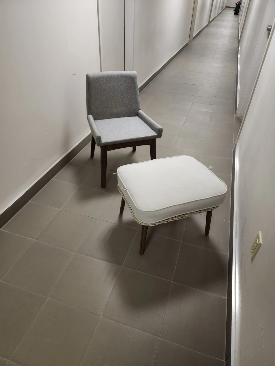 Grey upholstered accent chair with wooden legs