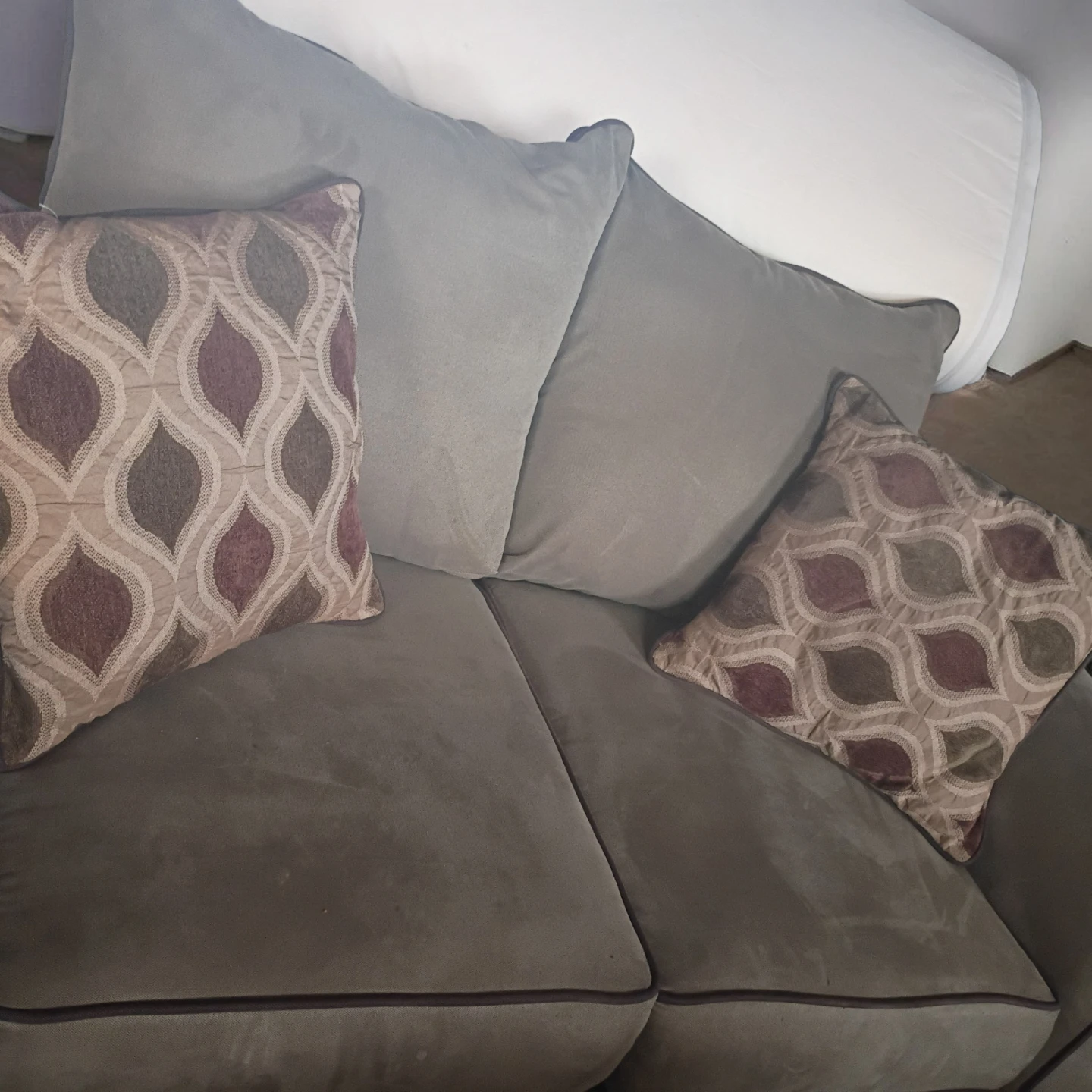 Light Brown Loveseat/Sofa with Decorative Pillows..