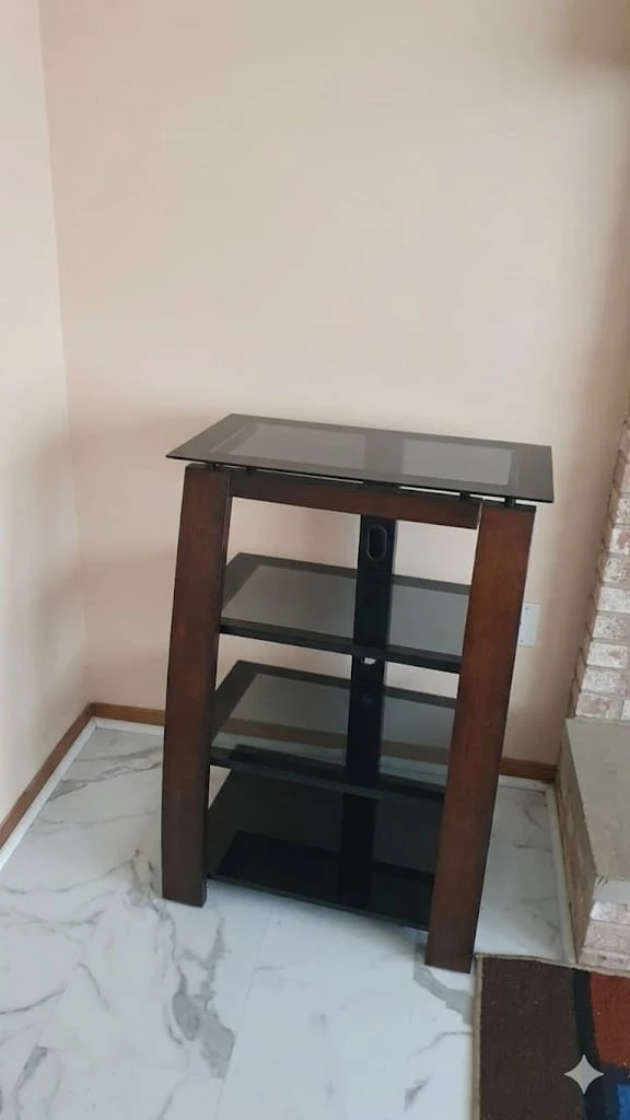 Wooden media console with glass shelves