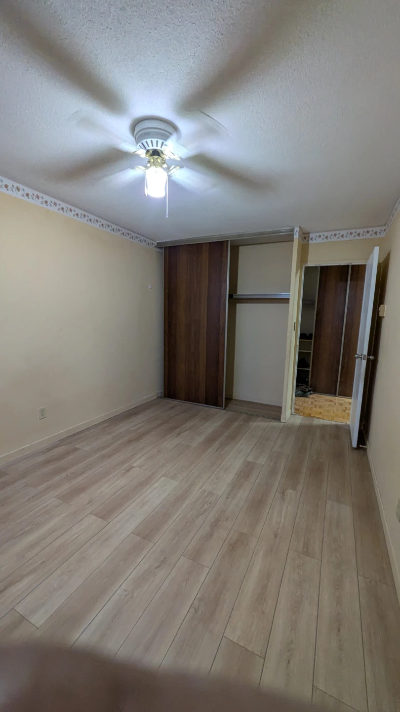 Bedroom with hardwood floors and closet