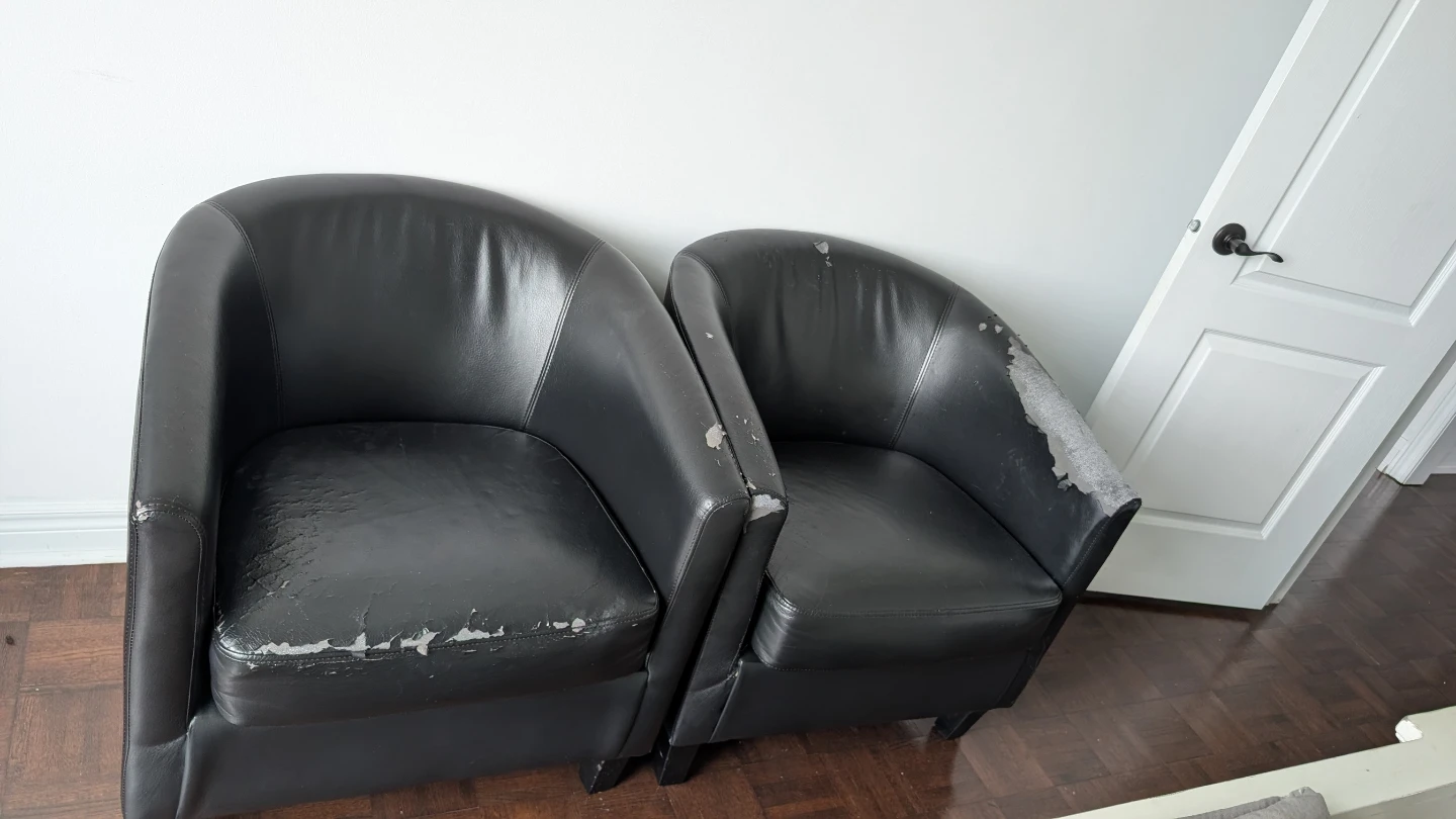 Two Black Leather Barrel Chairs