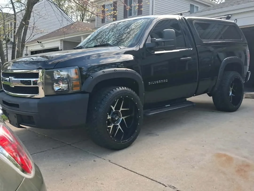 Black Chevrolet Silverado Truck with Cap