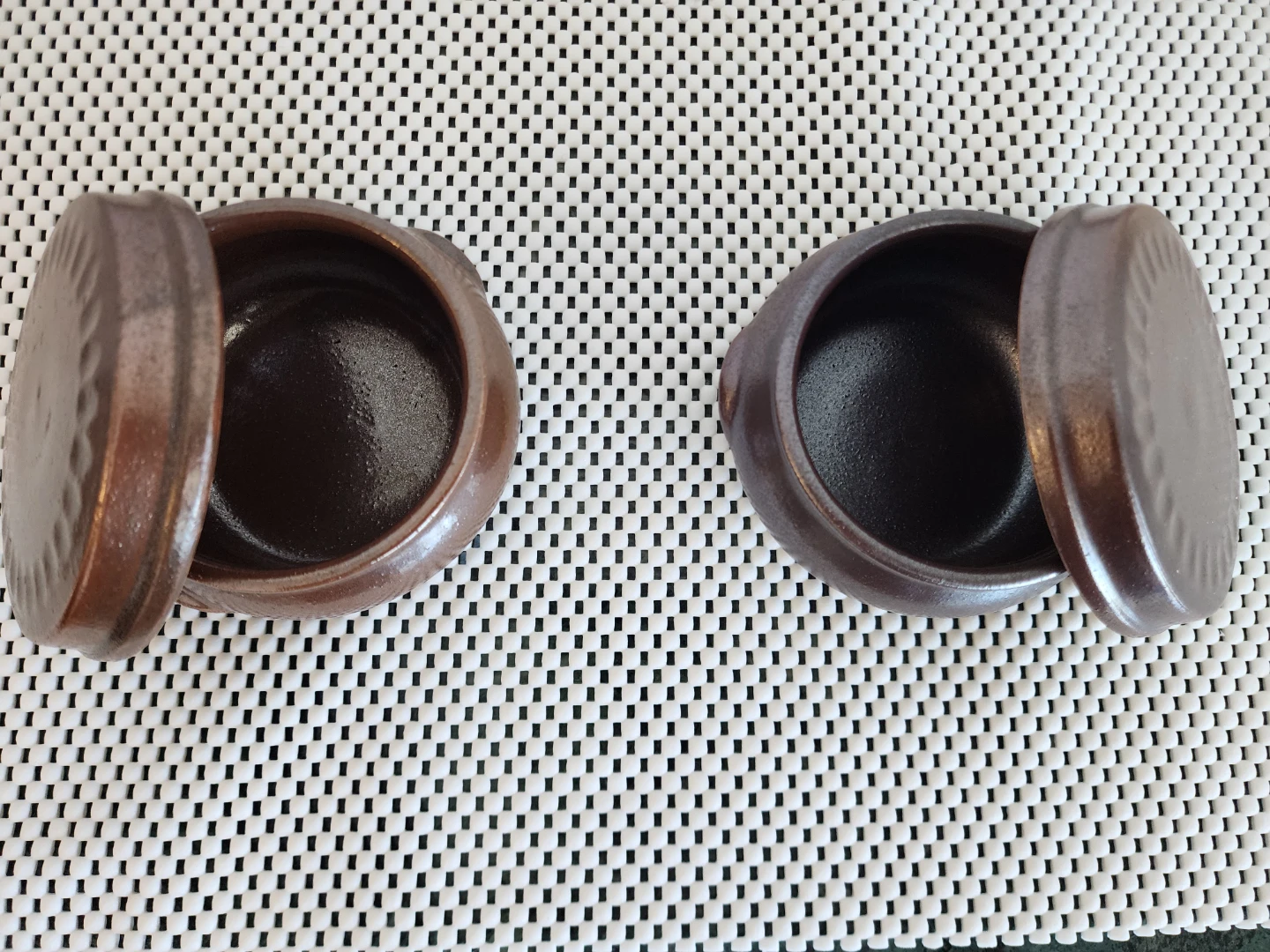Two small ceramic jars with lids