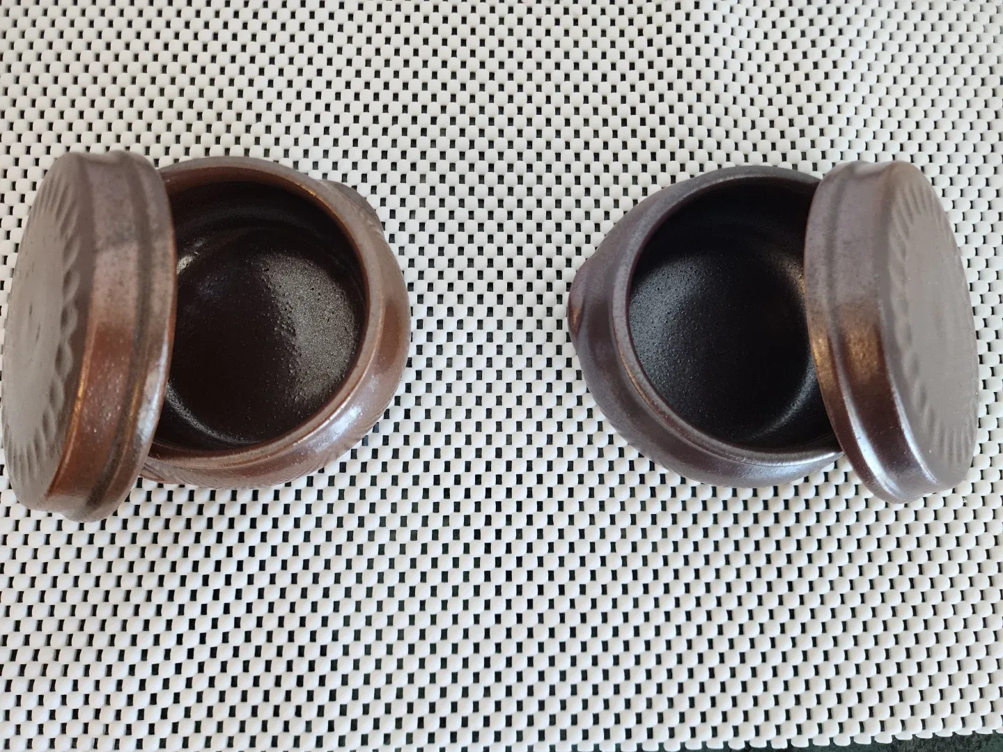 Two small ceramic jars with lids