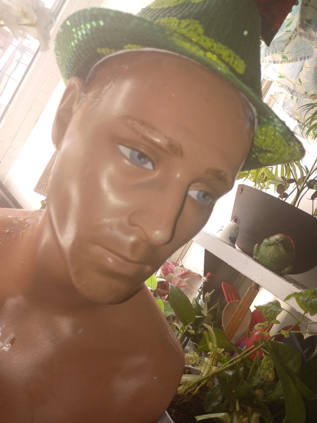 Mannequin torso and legs with green sequin hat