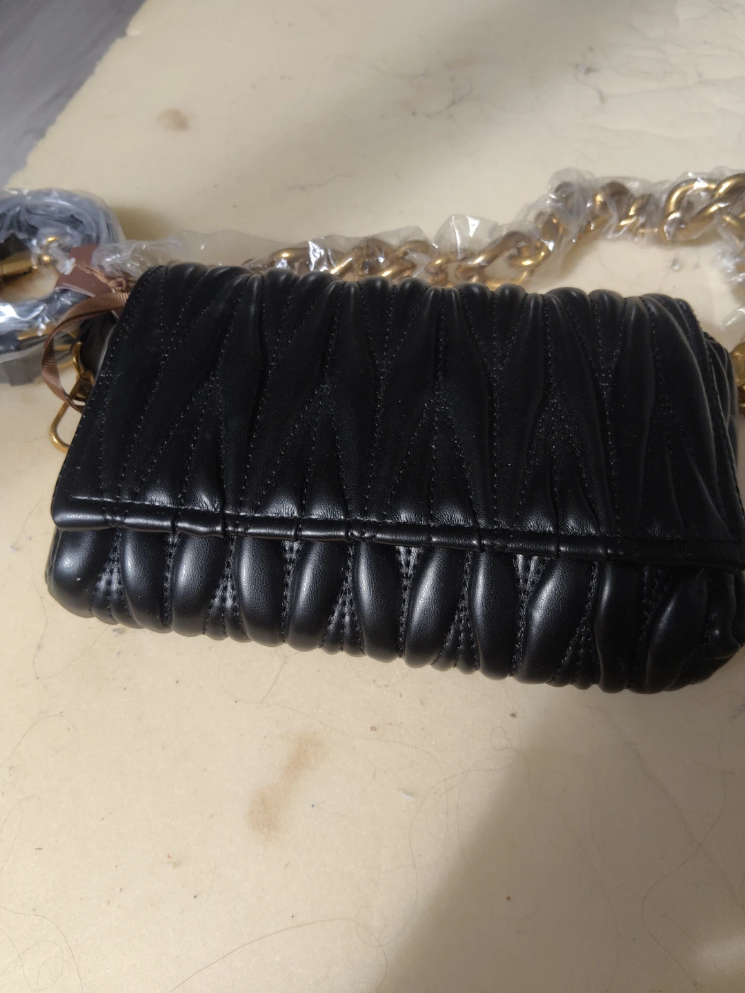 Black ruched clutch with gold chain strap