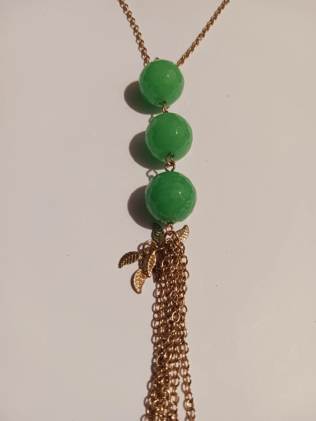 Gold tone necklace with green beads and tassel - photo 3