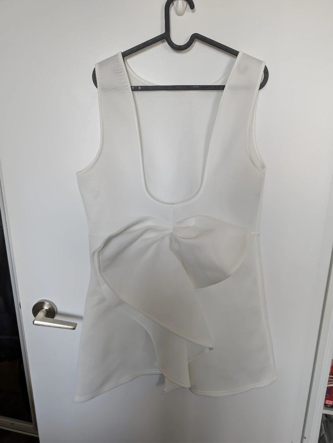 White sleeveless mini dress with bow detail