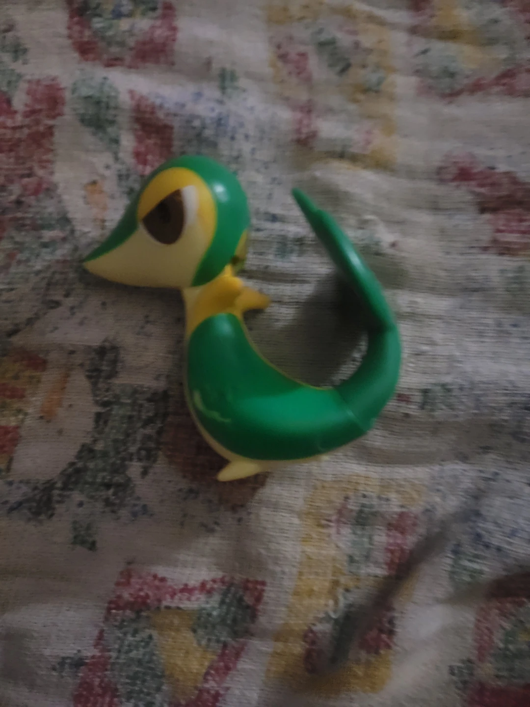 Pokémon Snivy action figure, likely from a 2011 or 2012