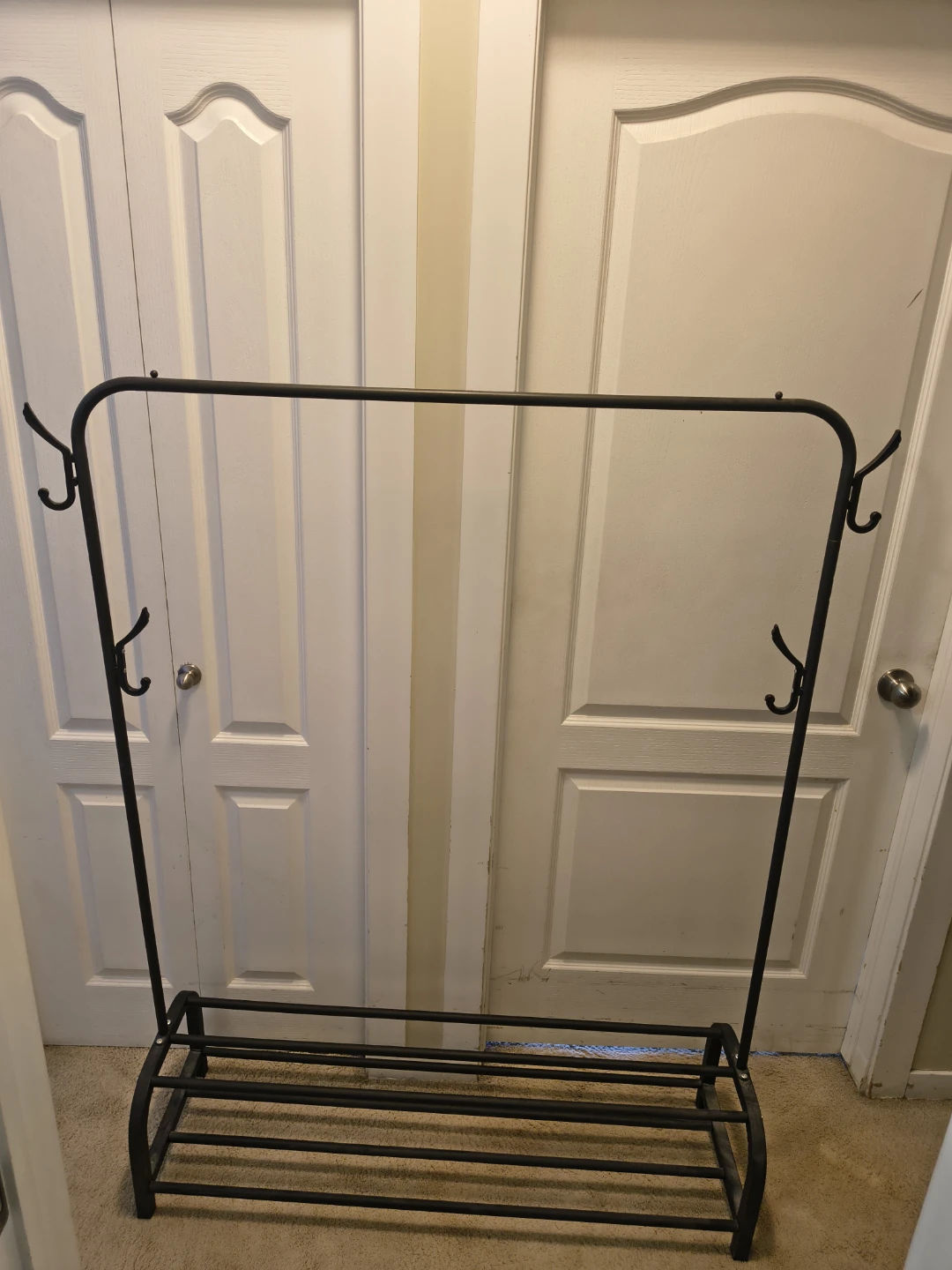 Black metal garment rack with shoe shelf