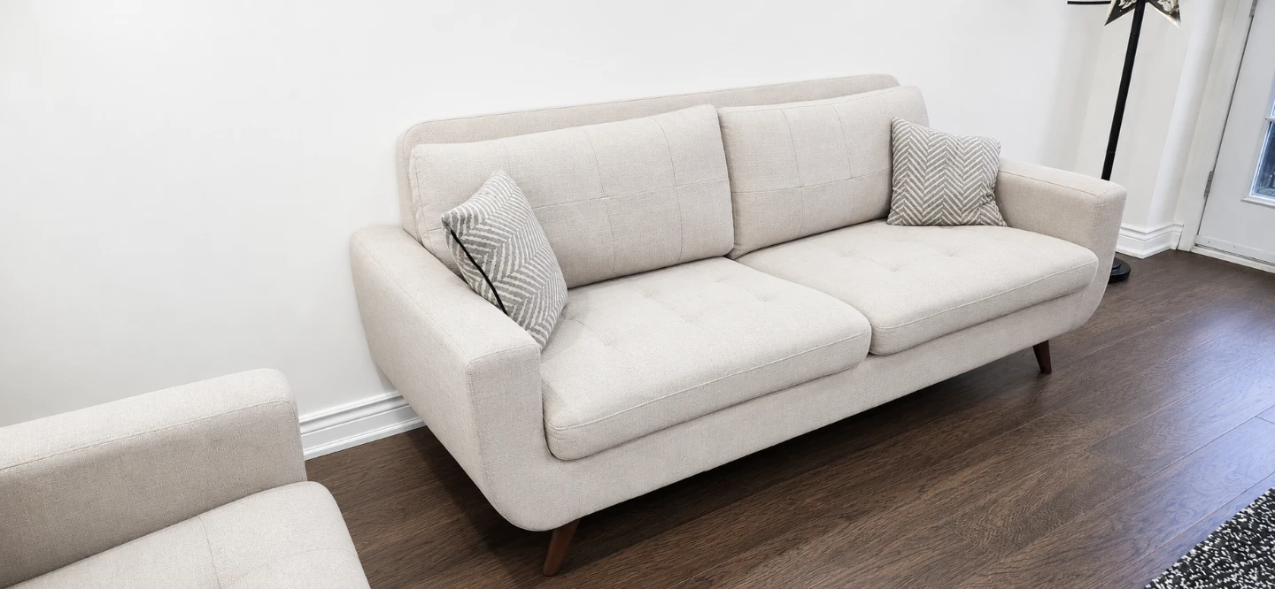 Beige Upholstered Sofa with Decorative Pillows