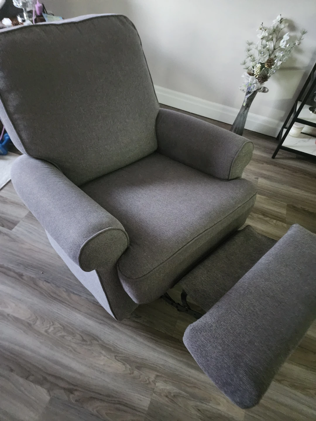 Grey upholstered glider chair with ottoman