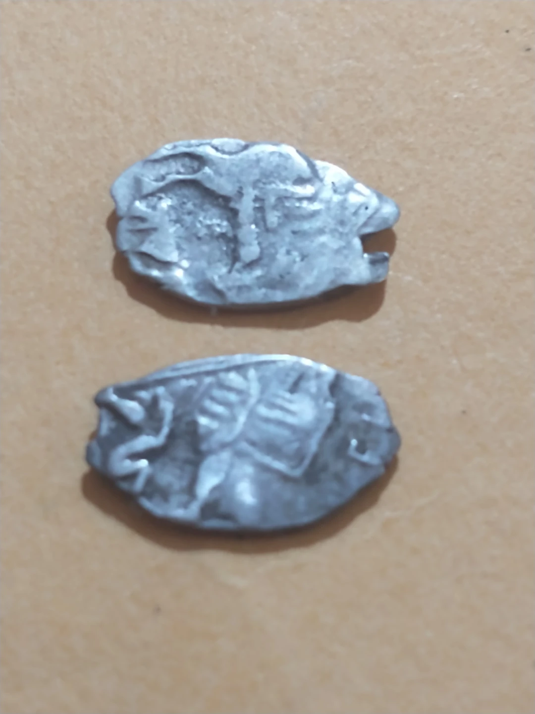 Two antique coins, silver colored