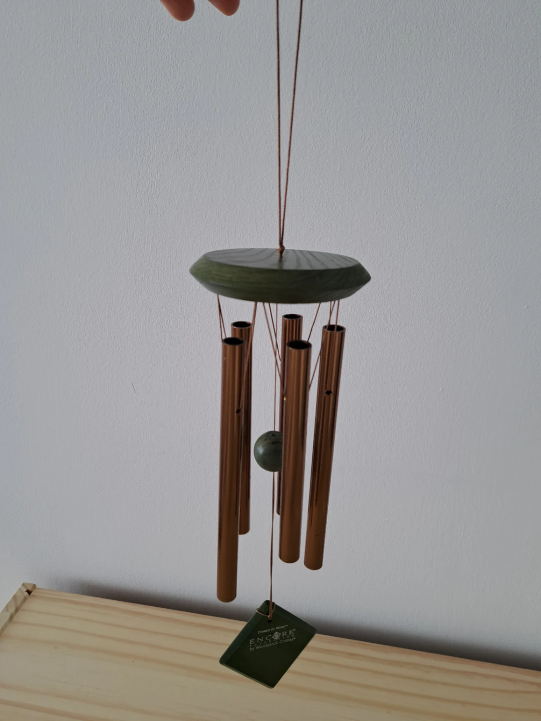 wooden and copper wind chime.
