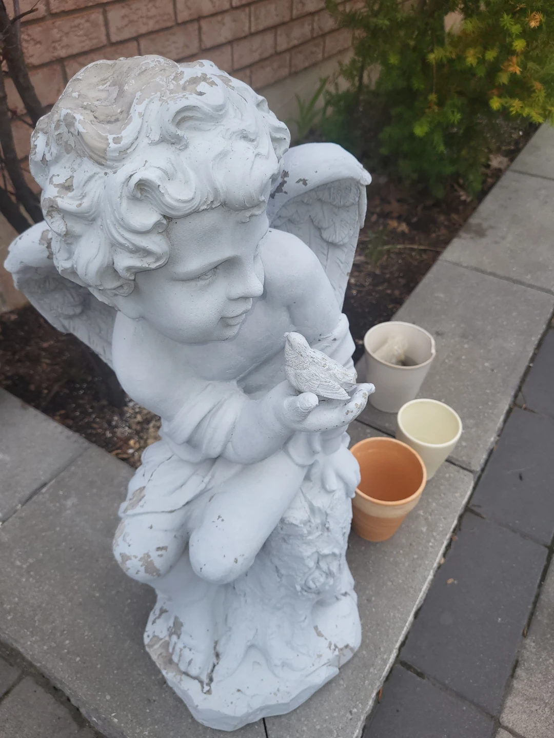 Beautiful angel with bird garden statue