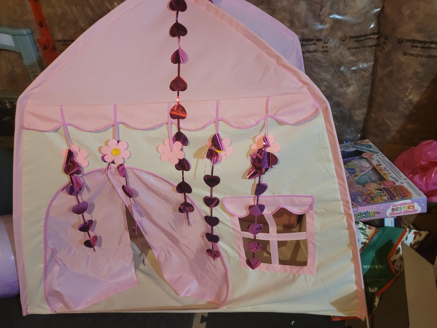 Pink play tent with hanging decorations