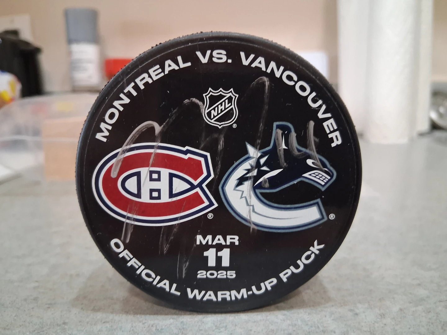 Autographed Montreal vs Vancouver warm up puck- Nick Suzuki.