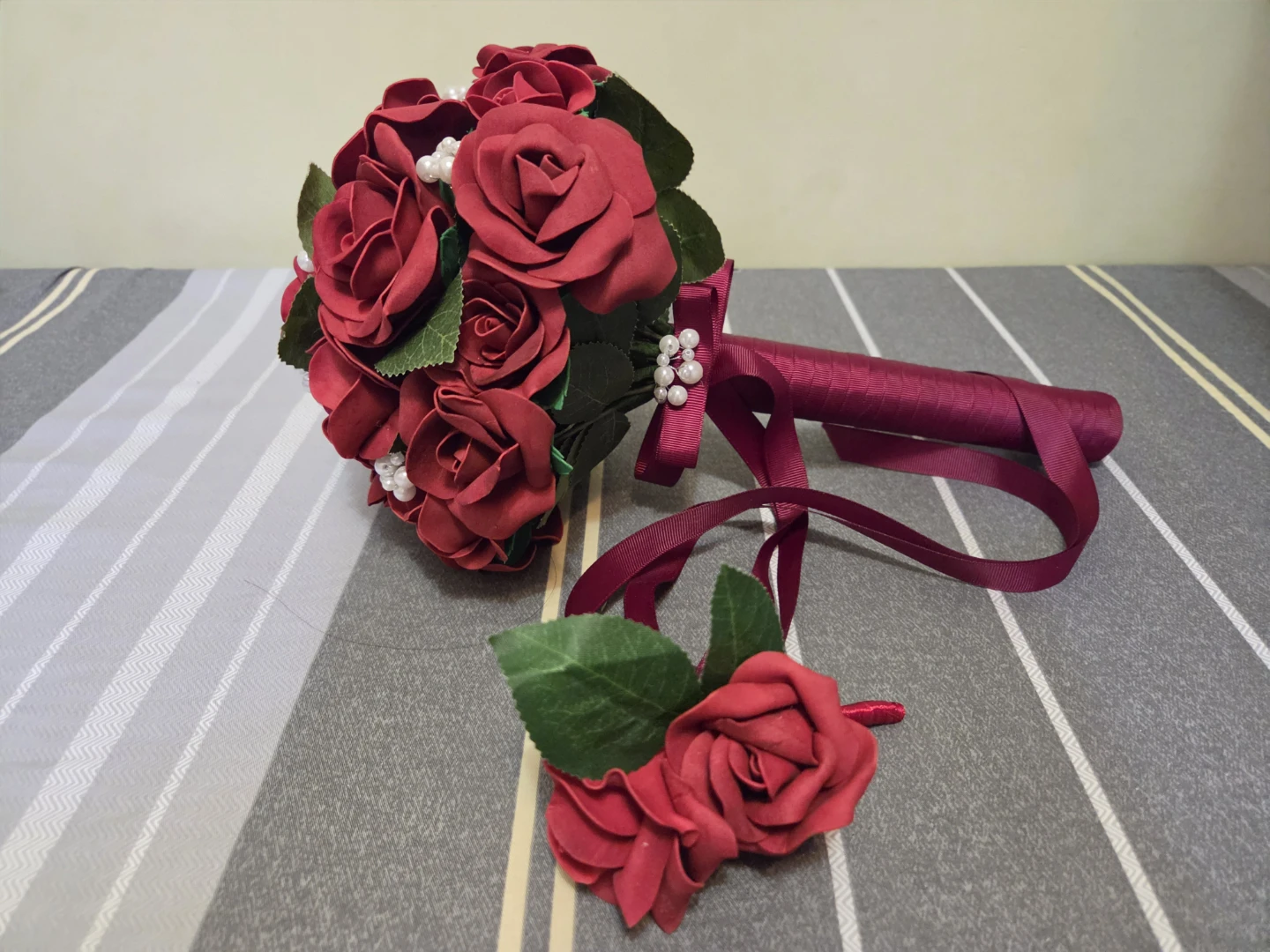 Red artificial rose bridal bouquet with boutonniere