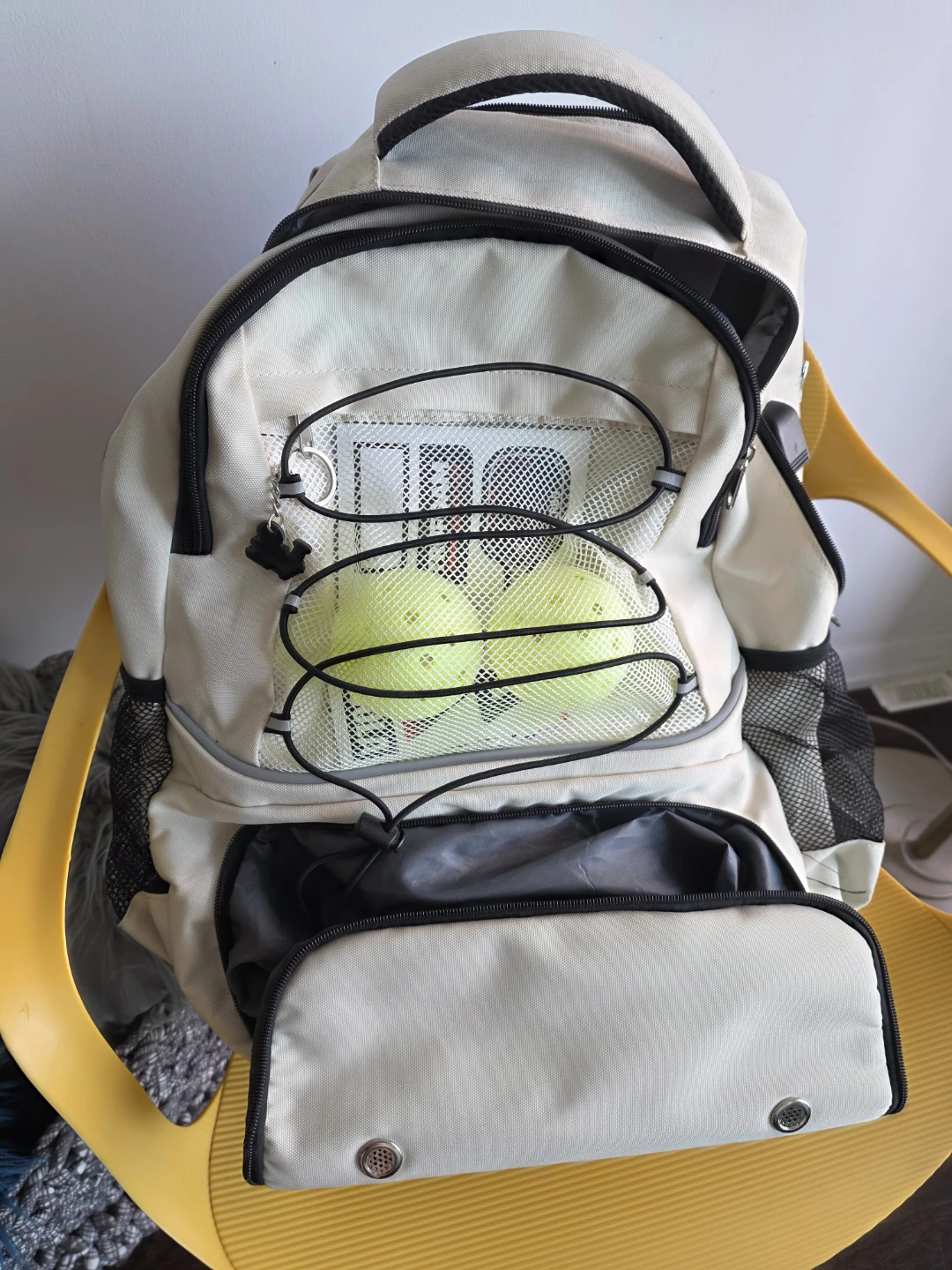 Cream and Black Backpack with Tennis Balls