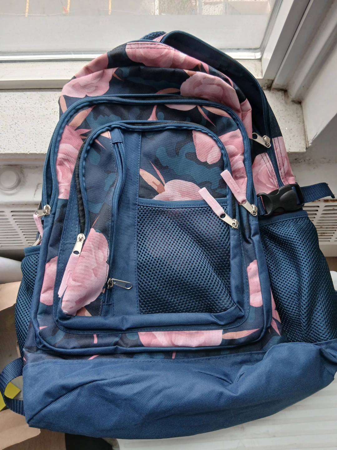 Blue floral backpack with pink accents