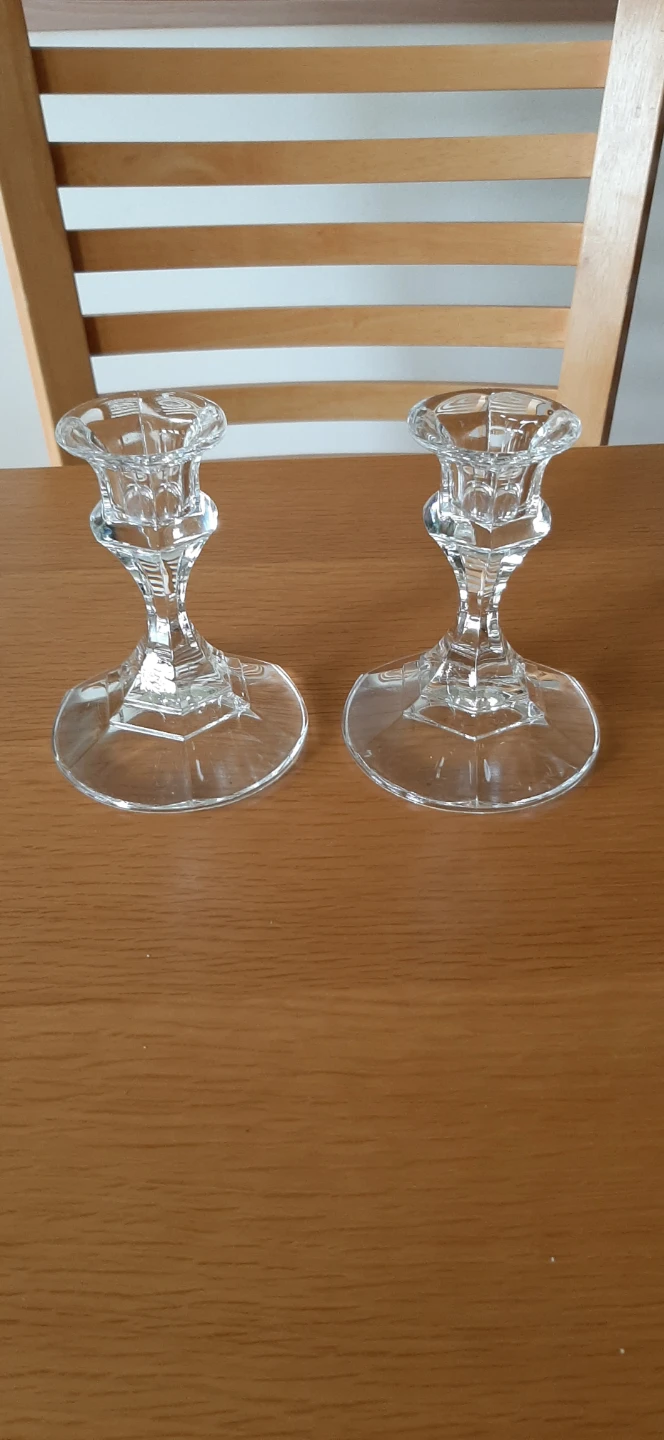 Set of two clear glass candle holders.