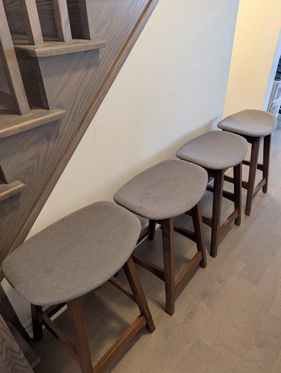 Set of 4 grey fabric saddle stools