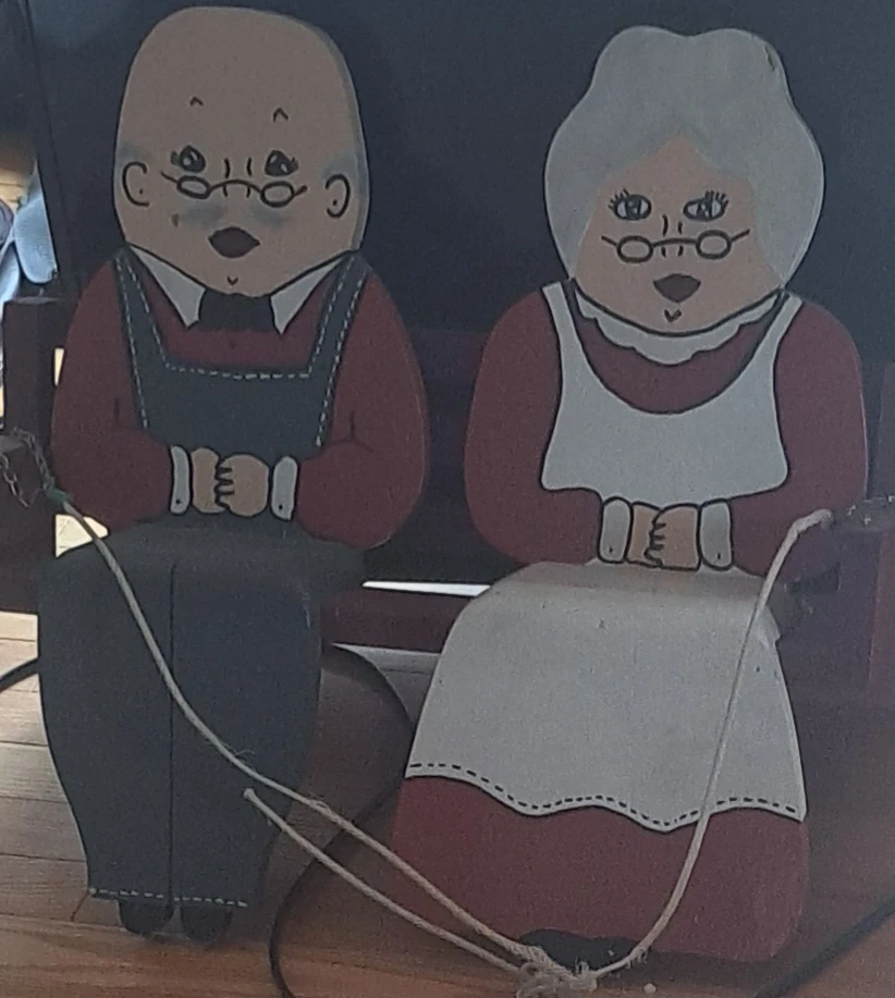 Wooden Couple Sitting on a Bench Figurine